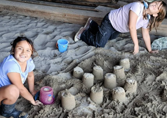 Two children building sand castles